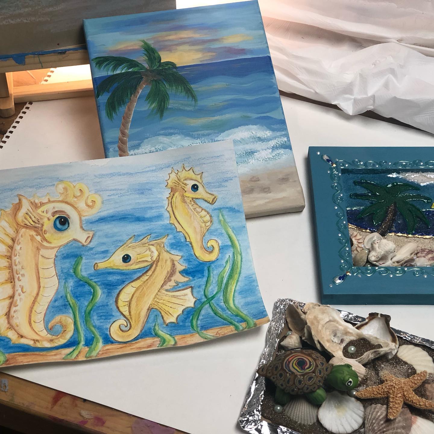 At the Beach camp projects include drawing, painting, and sand sculptures.